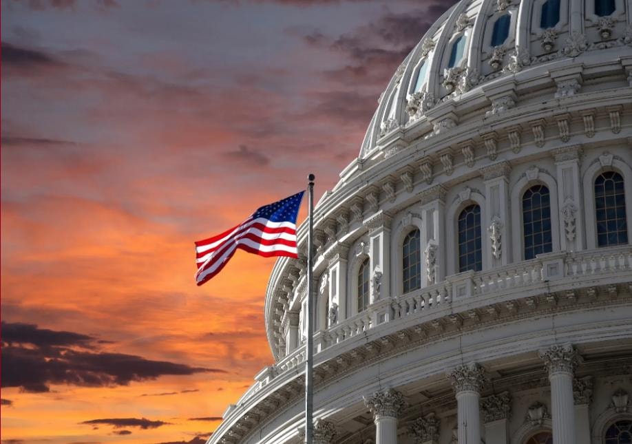 U.S. Capitol building with American flag at sunset